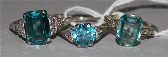An 18ct white gold and blue zircon ring with diamond set shoulders and two other gem set rings, one in 18ct gold, the other 9ct gold.